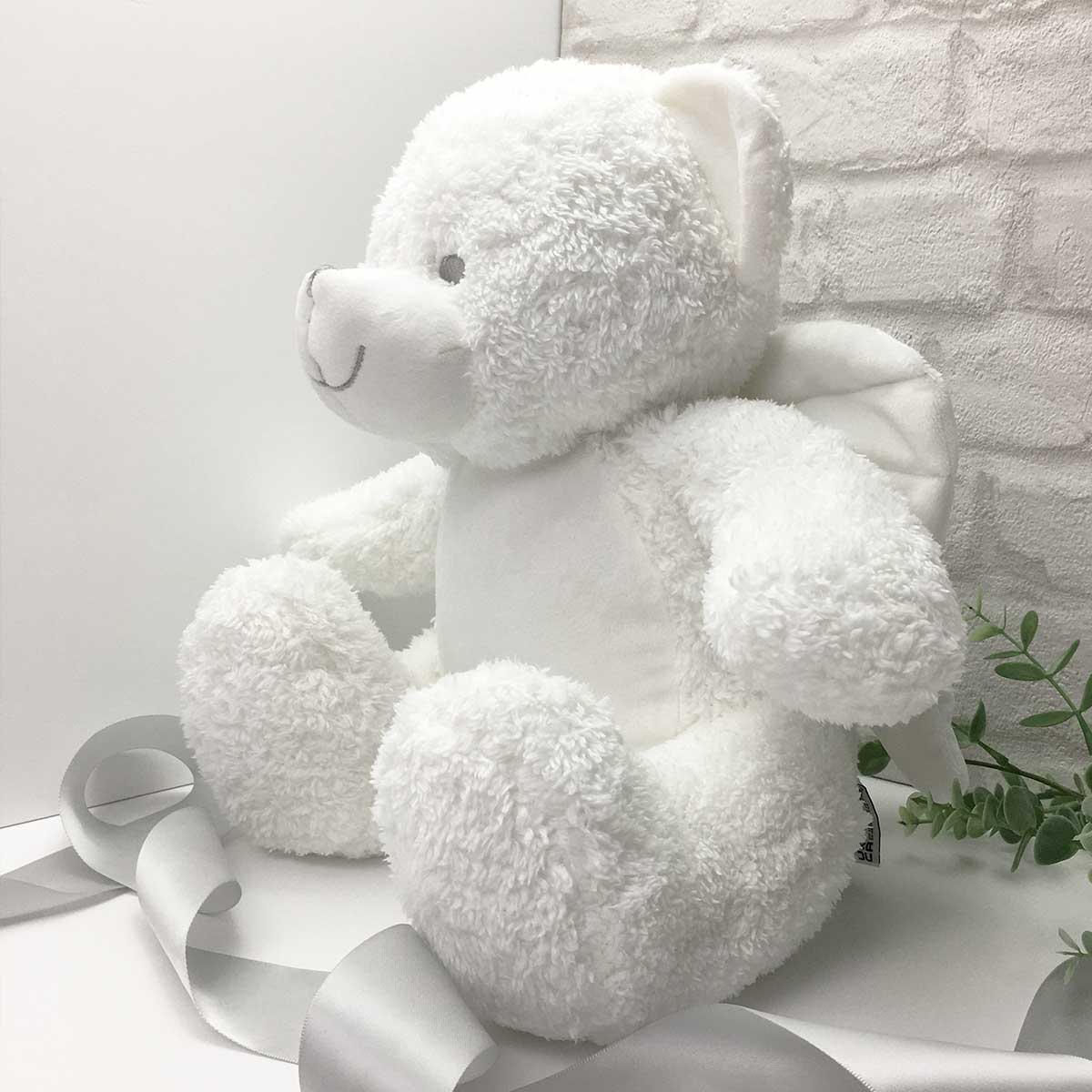 White teddy bear with shop wings